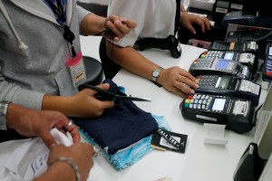 Sales staff accept payment by credit card at a department store in Bangkok